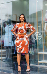 Elegant burnt orange abstract print sheath dress