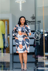 Vibrant black, white, and orange abstract shift dress.