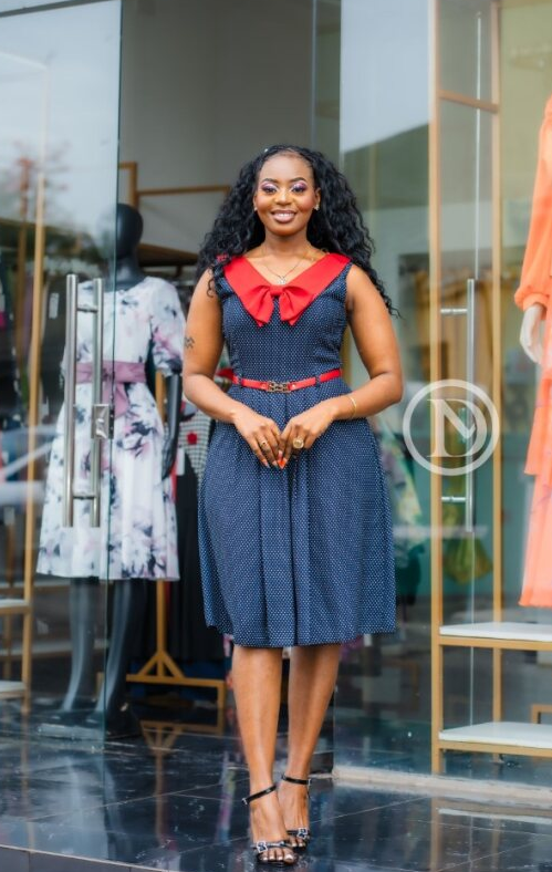 Classic sleeveless navy blue dress with white polka dots.