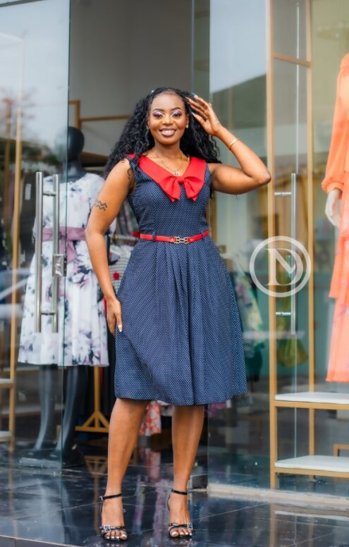 Classic sleeveless navy blue dress with white polka dots.